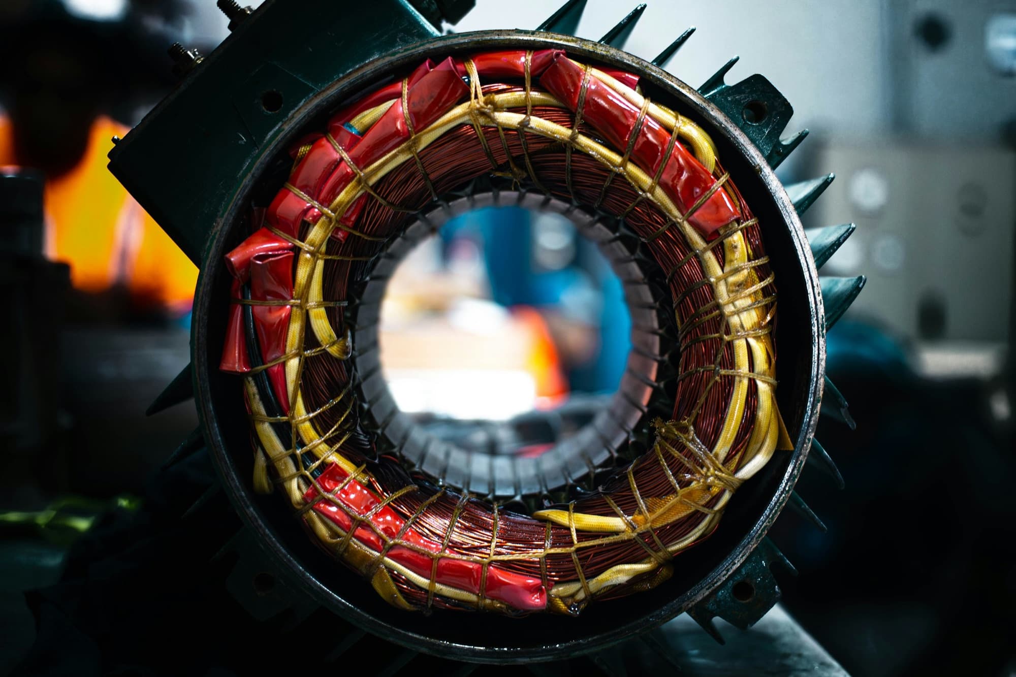 Electric motor stator with copper windings, insulation sleeving and laminated core inside a finned housing